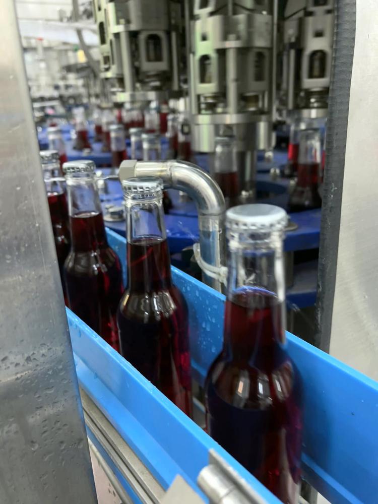 Bottles leaving the filler for quality checks